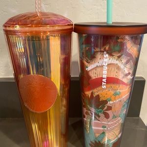2 Starbucks cups with straws